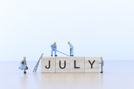 July words with Miniature people worker on wooden floor
の写真素材
