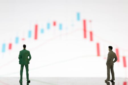 Miniature figures businessman standing on a graph chartの写真素材
