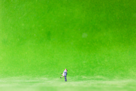Miniature couple on green yardの写真素材