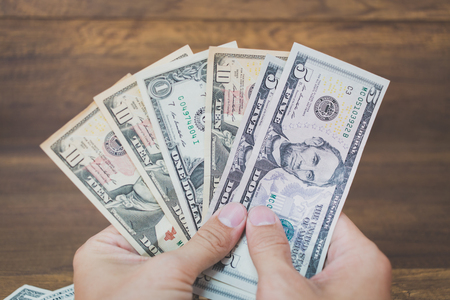US american dollar money bills  on wooden background