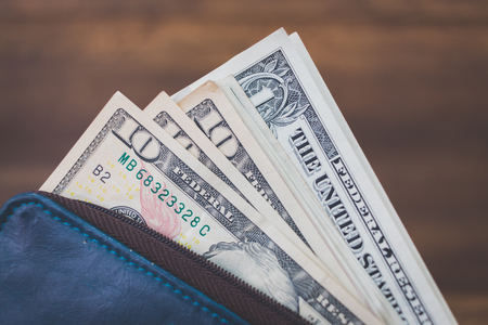 US american dollar money bills  on wooden background