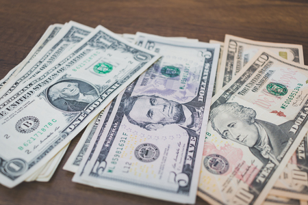 US american dollar money bills  on wooden backgroundの写真素材