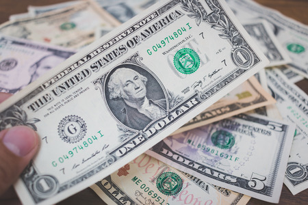 US american dollar money bills  on wooden backgroundの写真素材