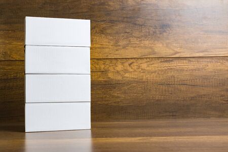 White paper box on wooden table background