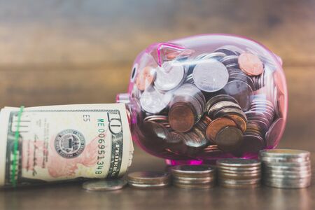 Saving concept ,  Coin In Piggy Bank on wooden backgroundの写真素材