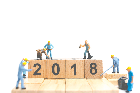 Miniature worker team building number on wooden block ,  Happy new year  2018
