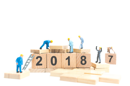 Miniature worker team building number on wooden block ,  Happy new year  2018