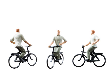 Miniature figure ride bicycle isolated on white background with clipping pathの写真素材
