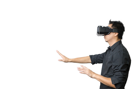 Young man using a VR headset and experiencing virtual reality isolated on white background with...