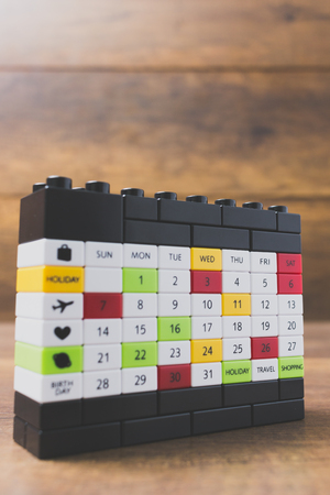 Colorful calendar plastic block on wooden backgroundの写真素材