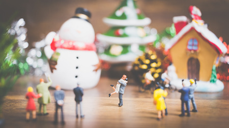 Miniature people in the village celebrate Christmas Day , Holiday concept. Joy, holiday, winter, happy, family, friendsの写真素材