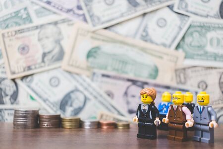 CHIANG MAI , THAILAND - September 23 , 2017 Miniature Business people with US dollar banknote backgroundのeditorial素材