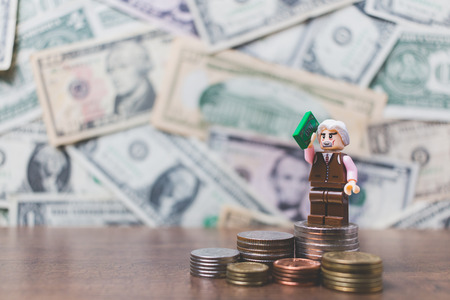 CHIANG MAI , THAILAND - September 23 , 2017 Miniature Business people with US dollar banknote backgroundのeditorial素材