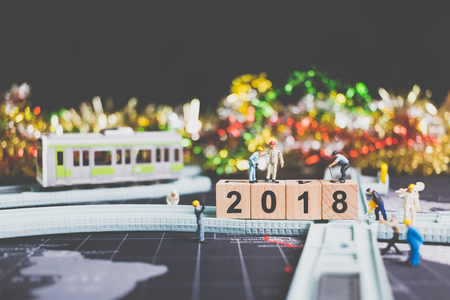 Miniature people worker build wooden block number 2018 on rail wayの写真素材