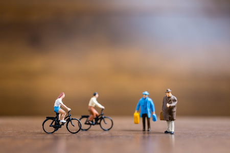 Miniature people travelers standing on wooden background , Travel conceptの写真素材