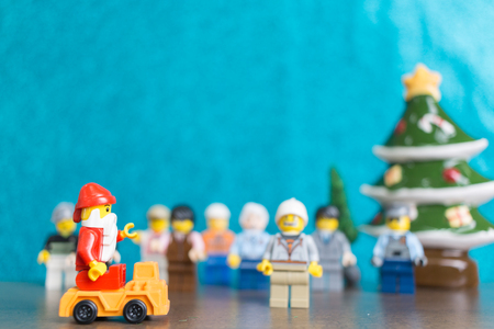 CHIANG MAI , THAILAND - November 12, 2017 Lego Santa Claus minifigure with Christmas scene on wooden floor and blue backgroundのeditorial素材