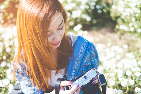 Portrait of Happy Asian woman holding camear  in The Chrysanthemum gardenの写真素材