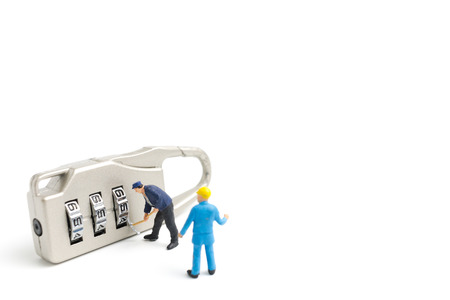 Miniature people worker  : Teamwork helps to unlock password on the keys. Team work concept.