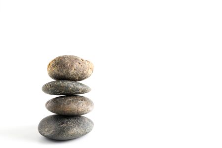 Stack of stones balancing isolated on white backgroundの写真素材