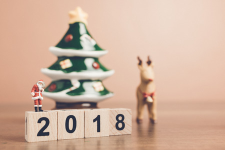Miniature people Santa Claus carrying bag , Christmas celebration concept.