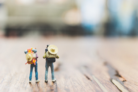 Miniature Backpacker , Tourist people standing on wooden with blurred  backgroundの写真素材
