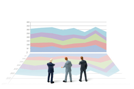 Miniature people : Businessman standing with chart on white background