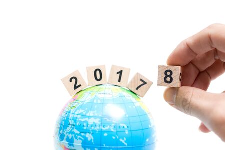 Hand holding Wooden block number 8 on globe map , New year concept