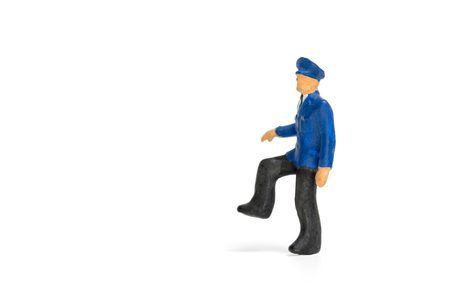Miniature people : Policeman standing isolate on white backgroundの写真素材