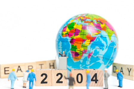 Miniature people : Businessman speaking on the podium , Earth day conceptの写真素材