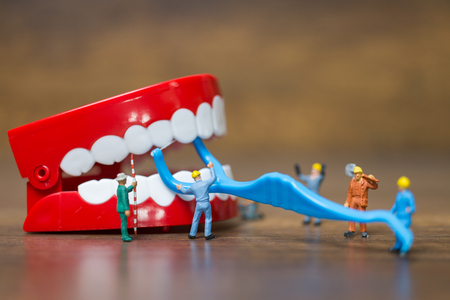 Miniature people : Worker team repairing a tooth ,Healthcare and medical conceptの写真素材
