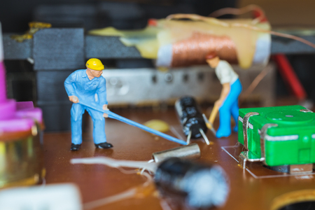 Miniature people : Worker team repairing Electronic Circuits. , Construction workers conceptの写真素材