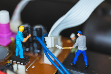 Miniature people : Worker team repairing Electronic Circuits. , Construction workers conceptの写真素材