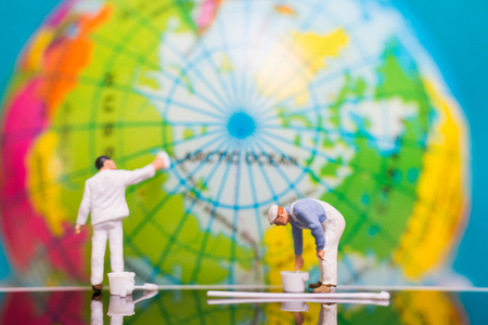 Miniature people : Painters painting on The globe  background , Earth day conceptの写真素材