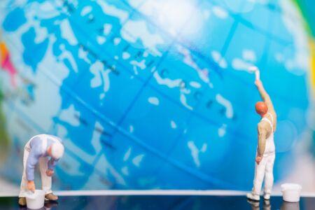 Miniature people : Painters painting on The globe  background , Earth day conceptの写真素材