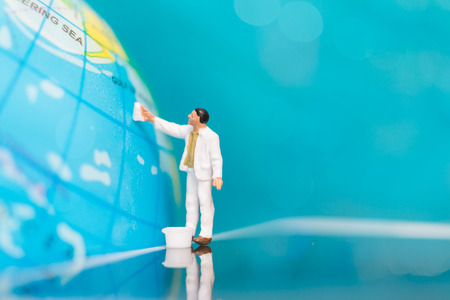 Miniature people : Painters painting on The globe  background , Earth day conceptの写真素材