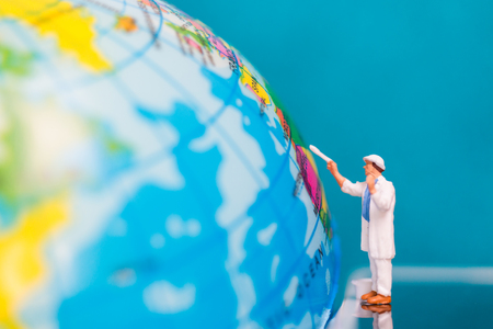 Miniature people : Painters painting on The globe  background , Earth day conceptの写真素材