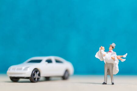 Miniature people : Bride and groom , Couple  on blue background.の写真素材