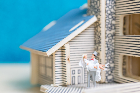 Miniature people : Bride and groom , Couple  on blue background.の写真素材