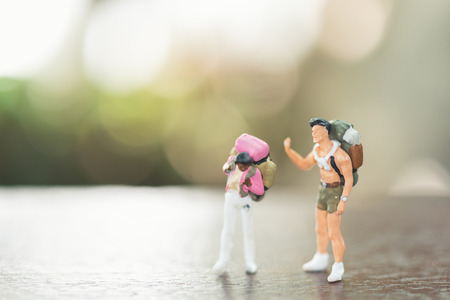 Traveler miniature people with backpack stand and walking , Travel and Adventure concepts.の写真素材