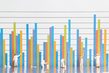 Miniature people : Worker painting business graph on white background , Business growth conceptの写真素材