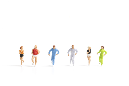 Miniature people running on white background , Healthy lifestyle and sport concepts.の写真素材