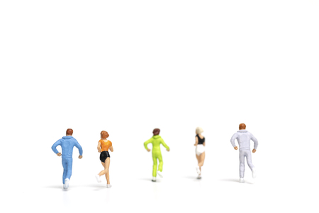 Miniature people running on white background , Healthy lifestyle and sport concepts.の写真素材