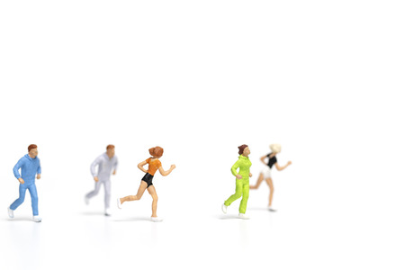 Miniature people running on white background , Healthy lifestyle and sport concepts.の写真素材