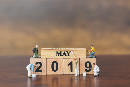 Miniature worker team painting  on wooden block , Happy new year 2019 conceptの写真素材