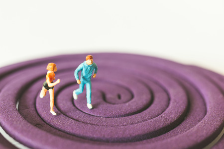 Miniature people : Couple Running on the purple field , Valentine's Day concept