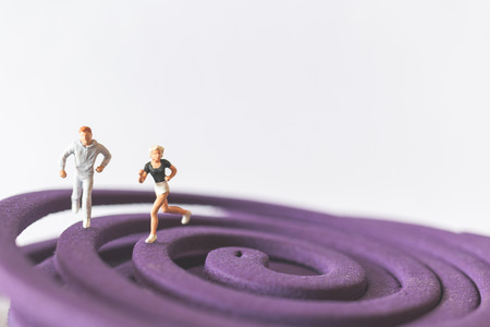 Miniature people : Couple Running on the purple field , Valentine's Day concept