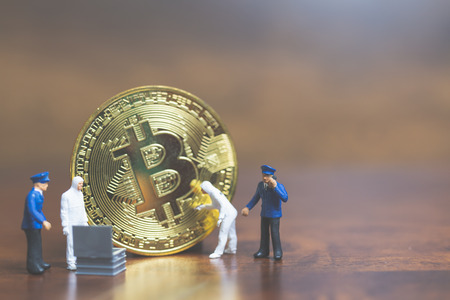 Miniature people : Police And Detective standing in front of Cryptocurrency bitcoin , Cyber crimes conceptの写真素材