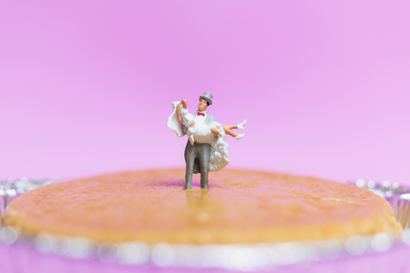 Miniature people wedding , bride and groom couple on pink  background , Valentine's Day conceptの写真素材