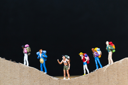 Miniature people :  Traveler with backpack walking on The paper mountain  . Travel and trekking Conceptの写真素材