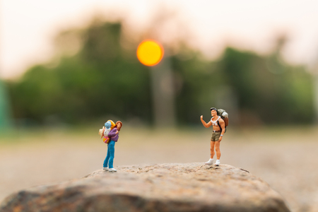 Miniature people : Traveler with backpack walking on the rock  , Travel and Adventure concepts.の写真素材